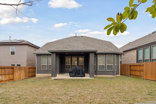 back of house with a lawn and a patio area