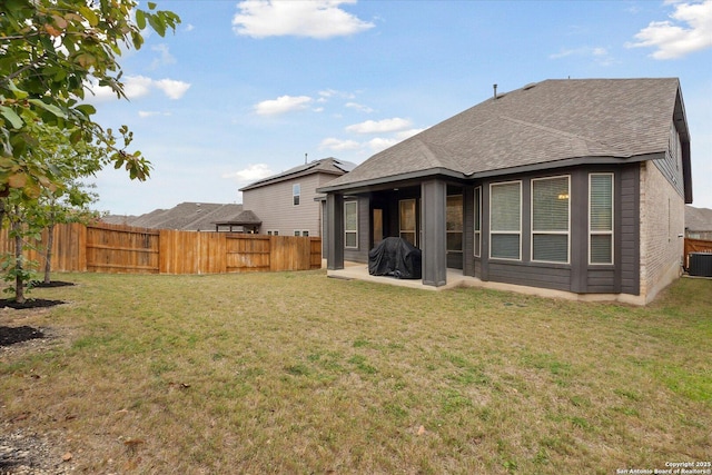 back of property featuring a lawn