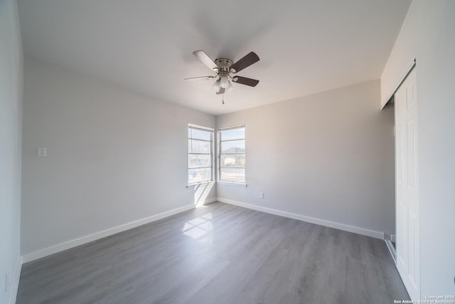 spare room with ceiling fan and dark hardwood / wood-style floors