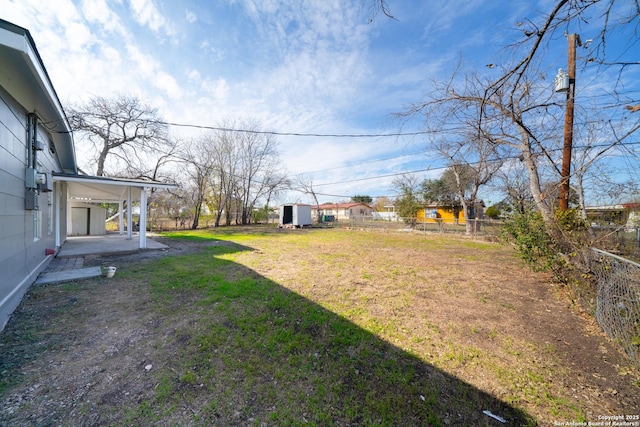 view of yard featuring a shed and a patio