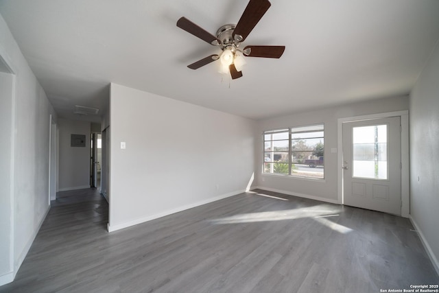 spare room featuring ceiling fan and dark wood-type flooring