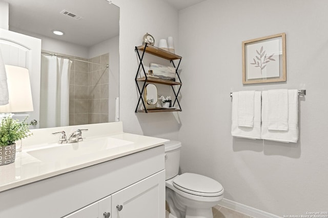 bathroom featuring toilet, vanity, and a shower with shower curtain