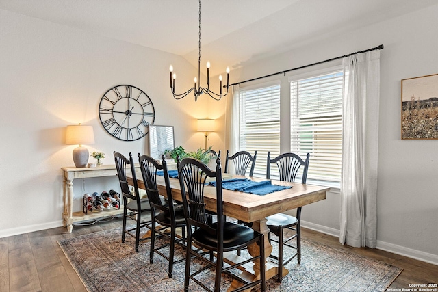 dining room featuring vaulted ceiling, dark wood-type flooring, and a notable chandelier