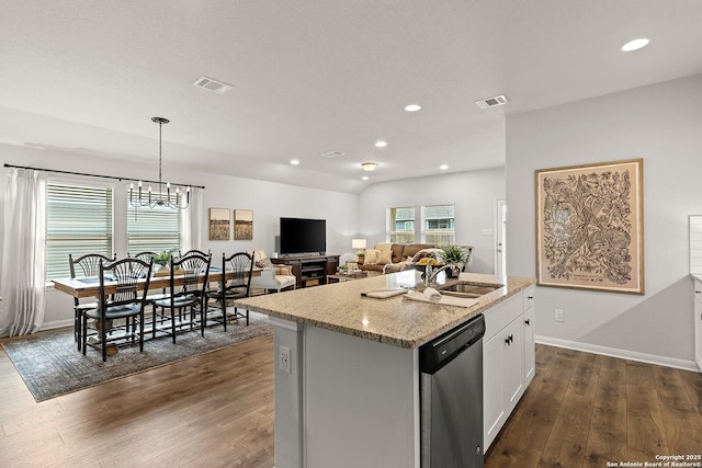 kitchen featuring white cabinetry, a kitchen island with sink, dishwasher, hanging light fixtures, and sink