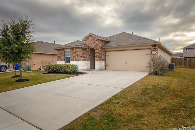 ranch-style home featuring central AC unit, a front yard, and a garage