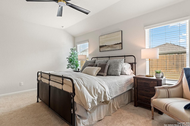 bedroom featuring ceiling fan, light colored carpet, and vaulted ceiling