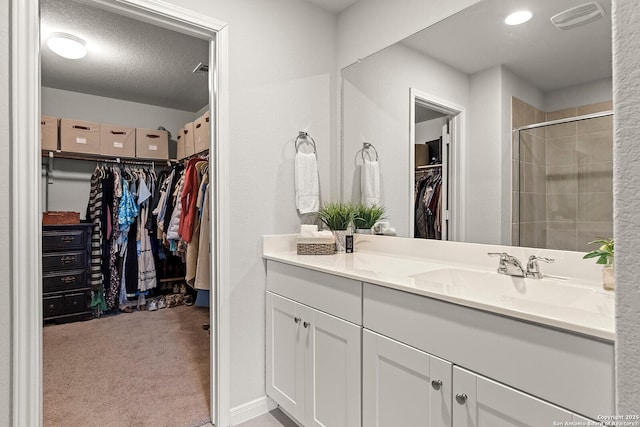 bathroom featuring a textured ceiling and vanity