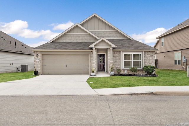 craftsman-style home featuring a garage, a front yard, and central AC unit