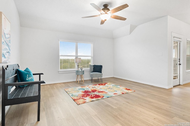 living area with ceiling fan and light wood-type flooring