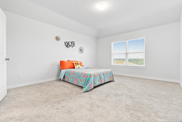 bedroom with carpet and vaulted ceiling