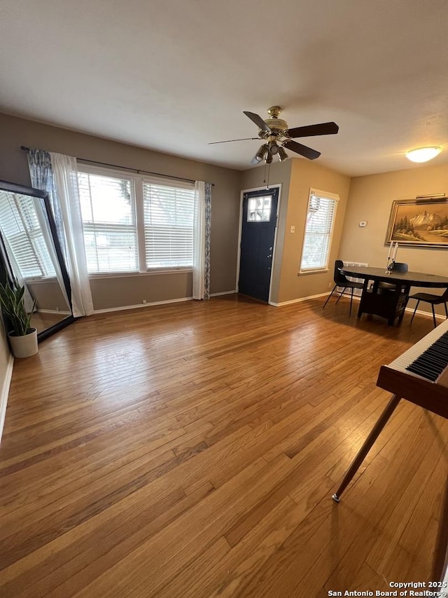 unfurnished living room with ceiling fan and hardwood / wood-style floors