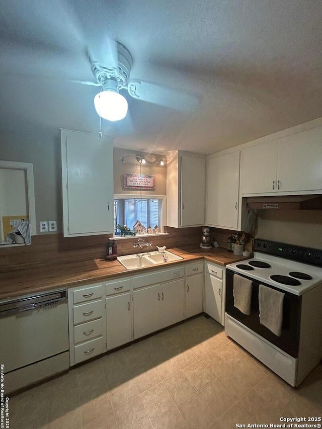 kitchen with white appliances, a textured ceiling, white cabinets, sink, and butcher block countertops