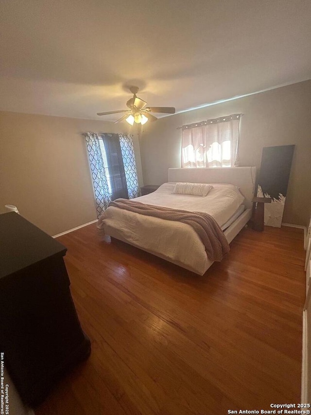 bedroom featuring ceiling fan and hardwood / wood-style floors