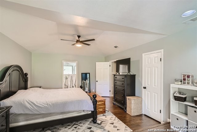 bedroom with ceiling fan and dark wood-type flooring