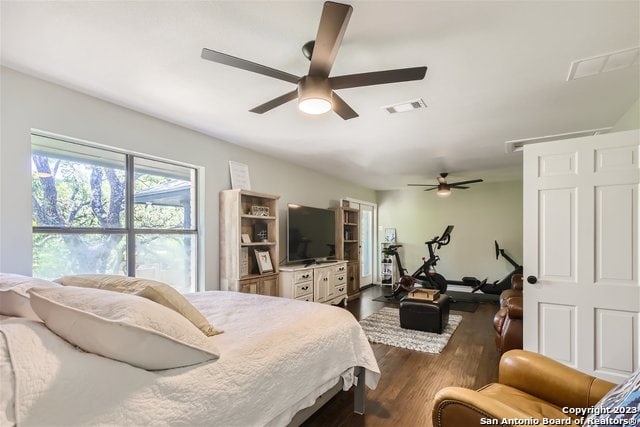 bedroom with ceiling fan and dark hardwood / wood-style floors