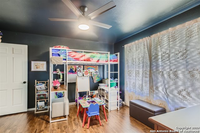 bedroom with ceiling fan and hardwood / wood-style floors