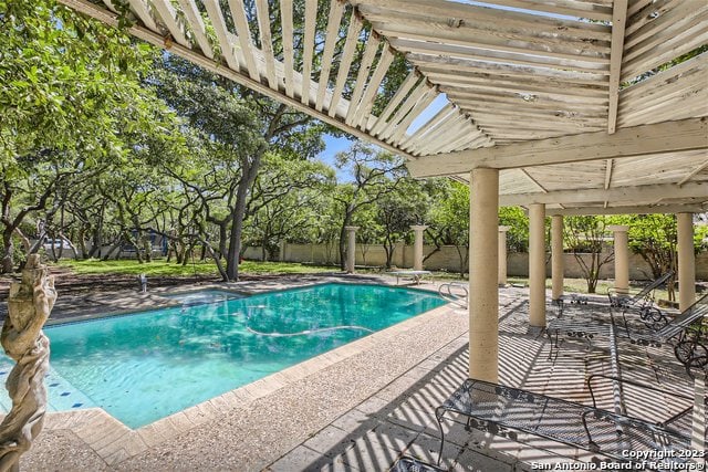 view of pool with a pergola and a patio