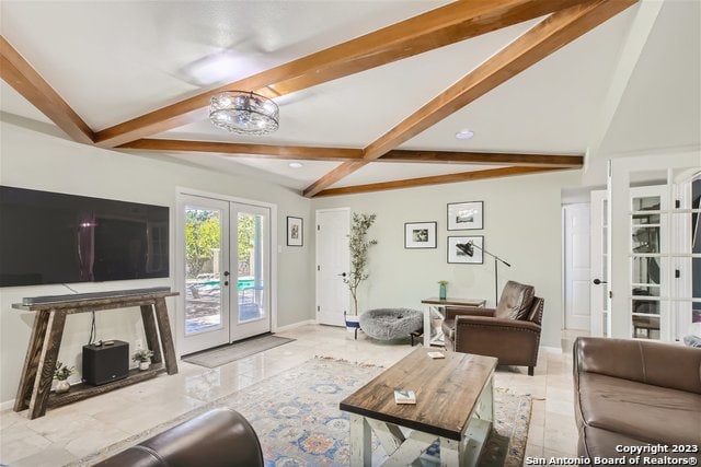 living room featuring beamed ceiling and french doors