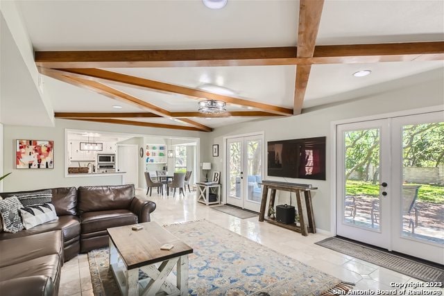 living room with beam ceiling and french doors