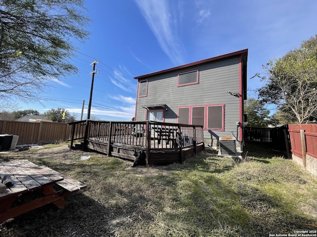 rear view of house featuring a deck, a yard, and central air condition unit