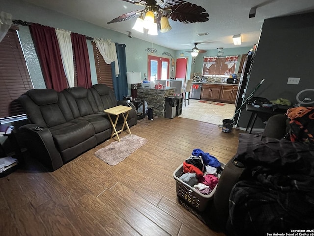 living room featuring light hardwood / wood-style floors and ceiling fan