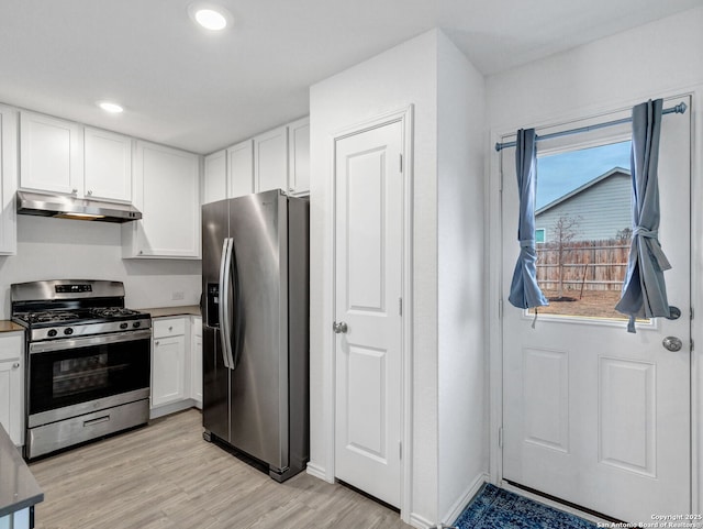 kitchen featuring white cabinets, appliances with stainless steel finishes, and light hardwood / wood-style flooring