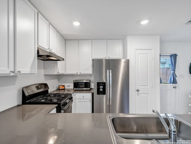 kitchen featuring appliances with stainless steel finishes, sink, and white cabinetry