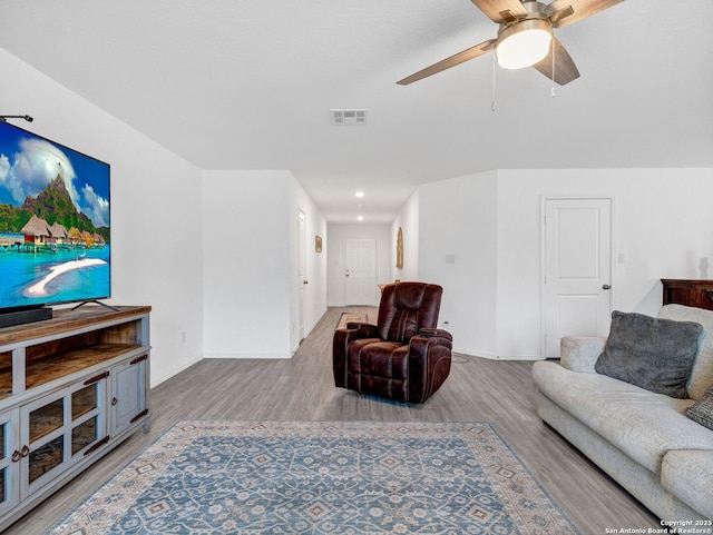 living room featuring ceiling fan and light wood-type flooring