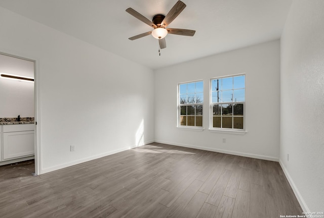 unfurnished room featuring ceiling fan, sink, and light hardwood / wood-style flooring