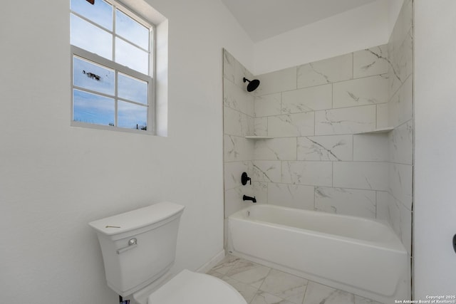 bathroom featuring toilet and tiled shower / bath