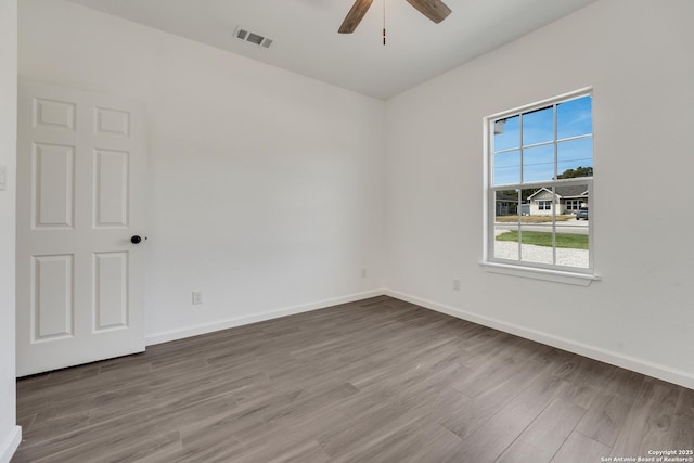 empty room featuring ceiling fan and hardwood / wood-style floors