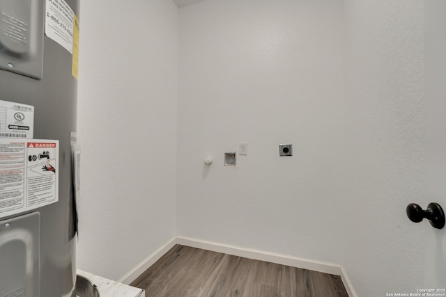 laundry area with electric water heater, electric dryer hookup, and hardwood / wood-style floors