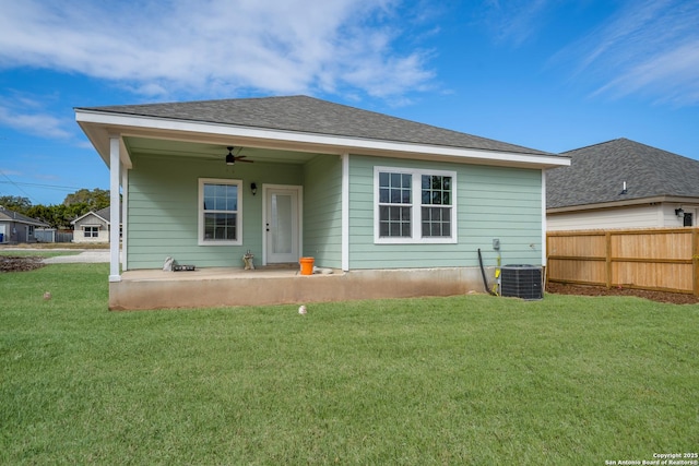 rear view of house featuring ceiling fan, central AC unit, a patio area, and a yard