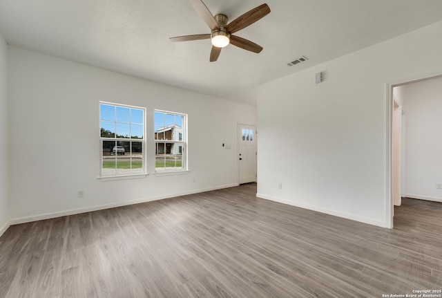 unfurnished room with ceiling fan and hardwood / wood-style flooring