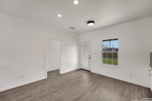 unfurnished room featuring wood-type flooring