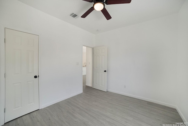 unfurnished bedroom with ceiling fan and light hardwood / wood-style flooring