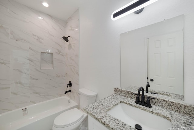 full bathroom featuring tiled shower / bath combo, vanity, and toilet