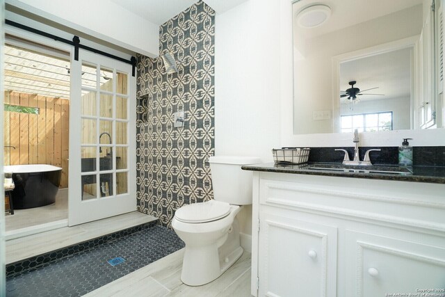 bathroom featuring toilet, ceiling fan, tile patterned flooring, and vanity