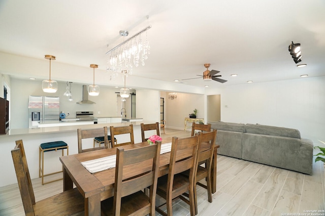 dining space featuring ceiling fan and light wood-type flooring