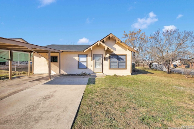 view of front of home with a front lawn and a carport