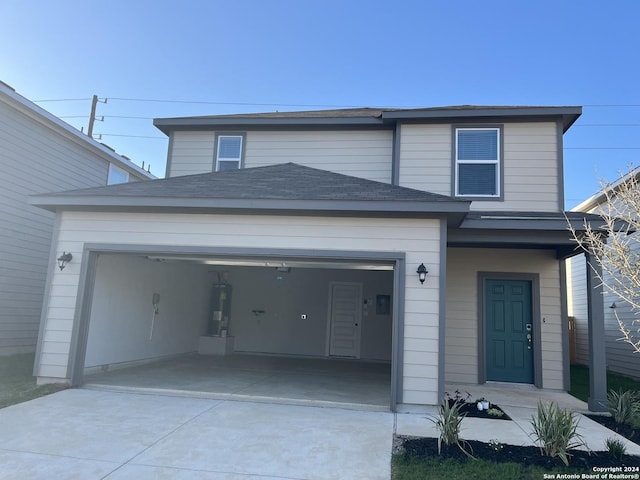 view of front of house featuring a garage and electric water heater