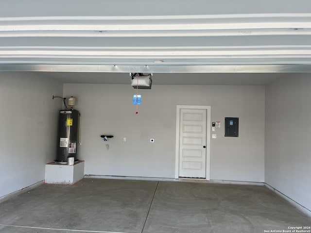 garage with water heater, a garage door opener, and electric panel