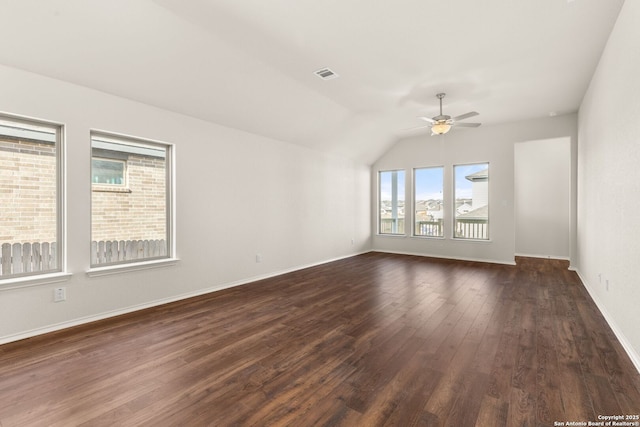 empty room with lofted ceiling, dark wood-type flooring, and ceiling fan