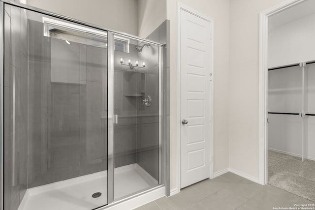 bathroom featuring an enclosed shower and tile patterned flooring