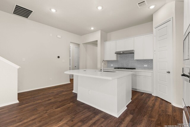 kitchen with dark wood-type flooring, sink, a kitchen island with sink, and white cabinets