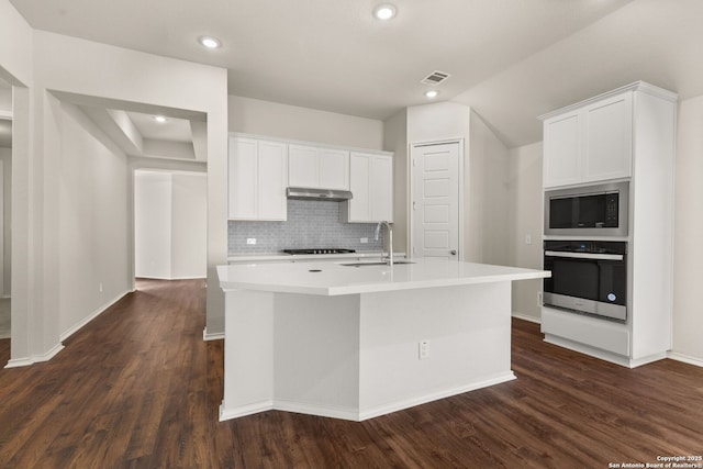 kitchen with sink, a center island with sink, appliances with stainless steel finishes, dark hardwood / wood-style flooring, and white cabinets