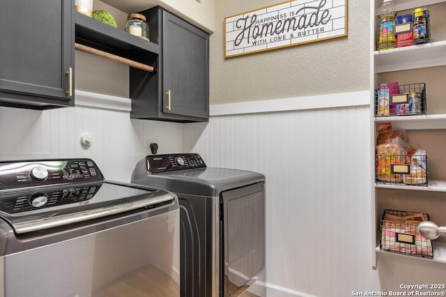 clothes washing area with independent washer and dryer and cabinets