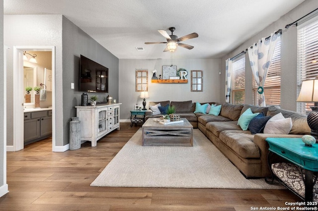 living room featuring ceiling fan and wood-type flooring