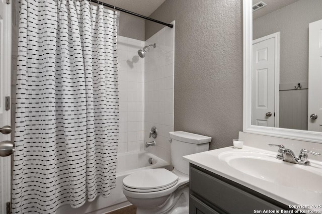 full bathroom with a textured ceiling, toilet, vanity, and shower / bath combo