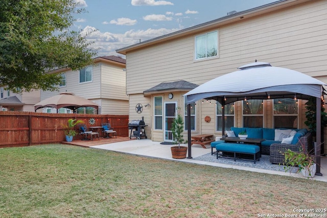 back of house featuring an outdoor living space, a gazebo, a yard, and a patio